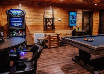 Carmel presidential pool table and Big Buck arcade machine in cabin game room