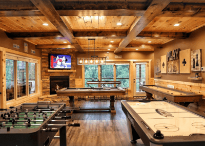 viena pool table, shuffleboard, foosball, air hockey, and multicade machine in a cabin gameroom